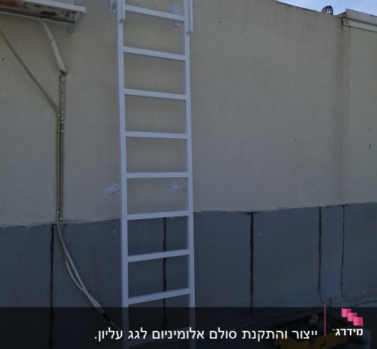 סולם מותקן על קיר עם כלי עבודה על הרצפה
